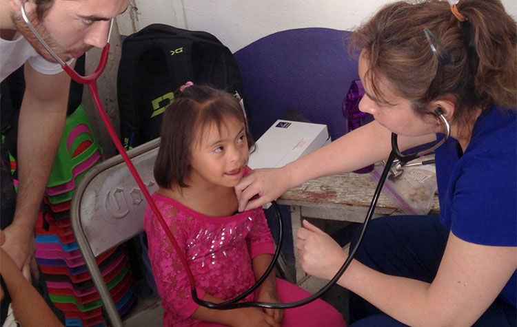 Child getting a medical exam from Operation Serve International