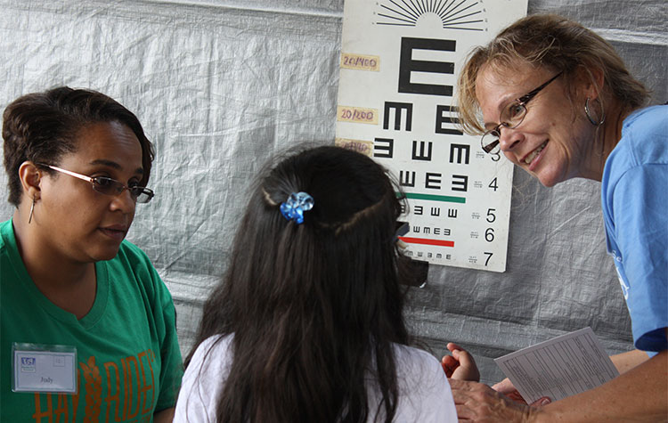 Child taking an eye exam with Operation Serve International