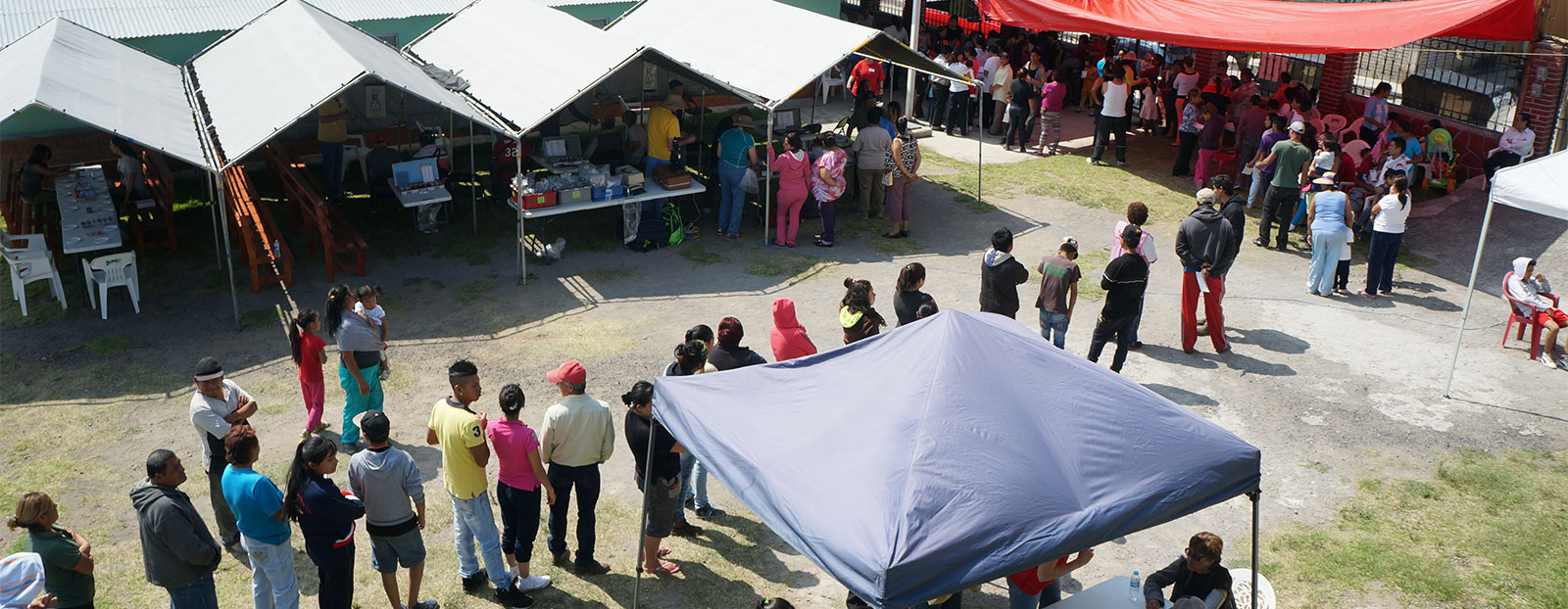 People waiting in line for health and medical services provided by Operation Serve International