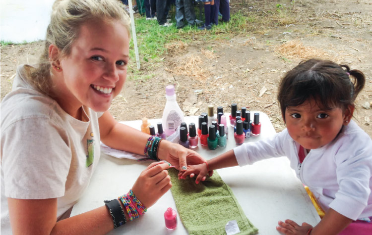 Intern paying a child's nail in Mexico