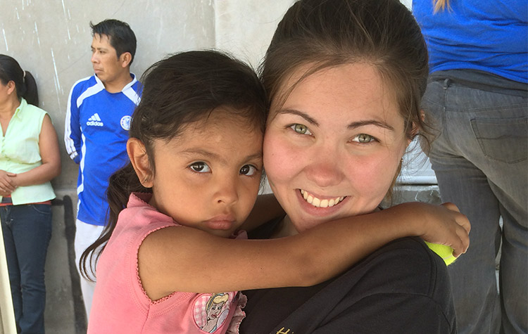 Intern holding a child