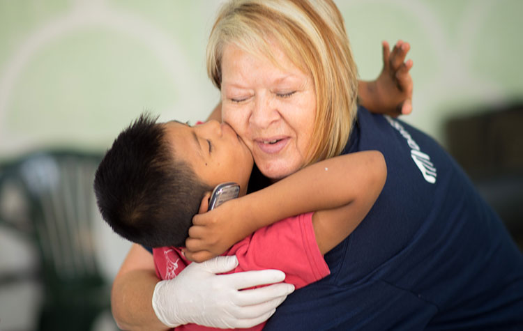 Lady hugging a child